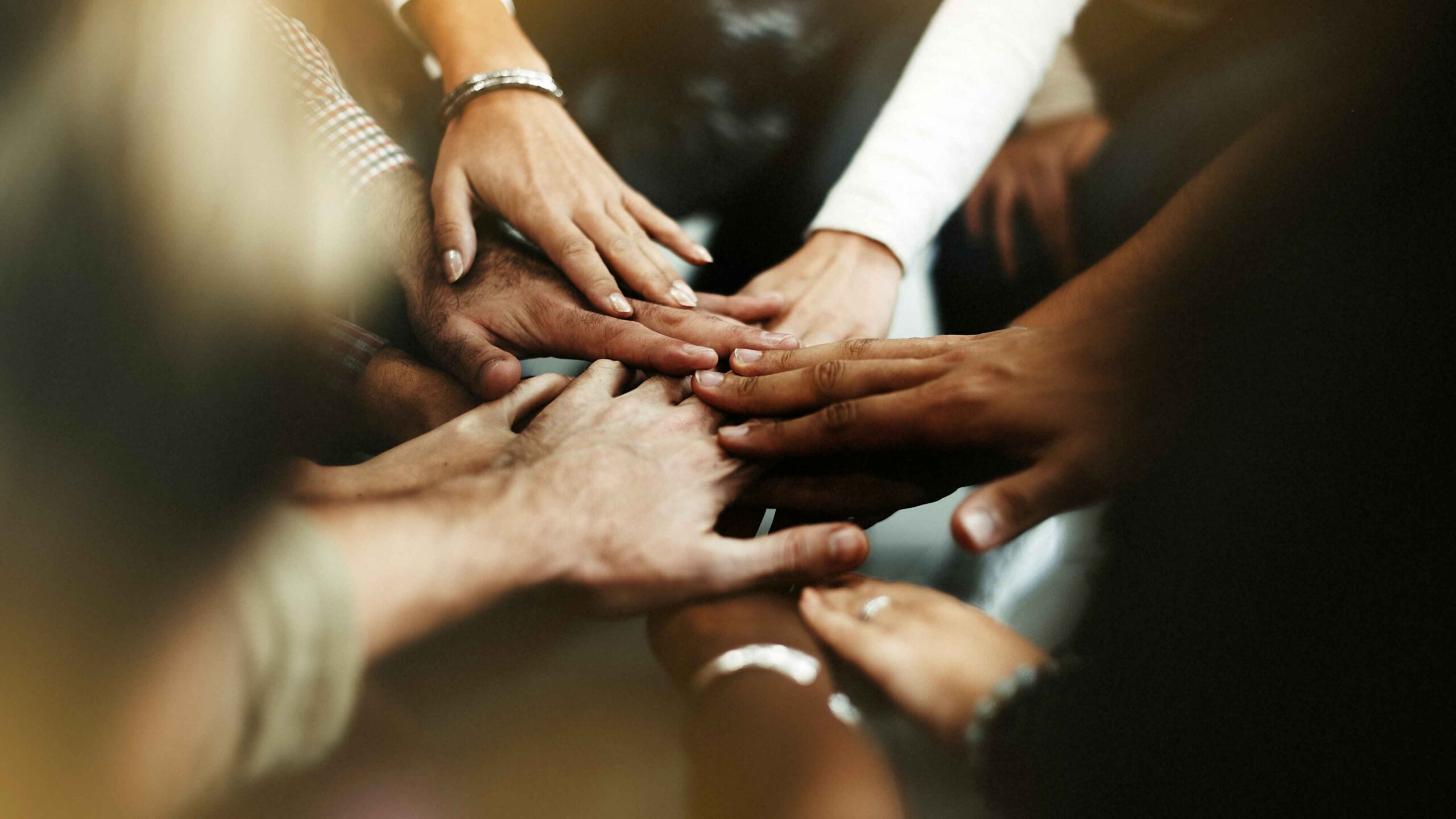 closeup-diverse-people-joining-their-hands-low-quality